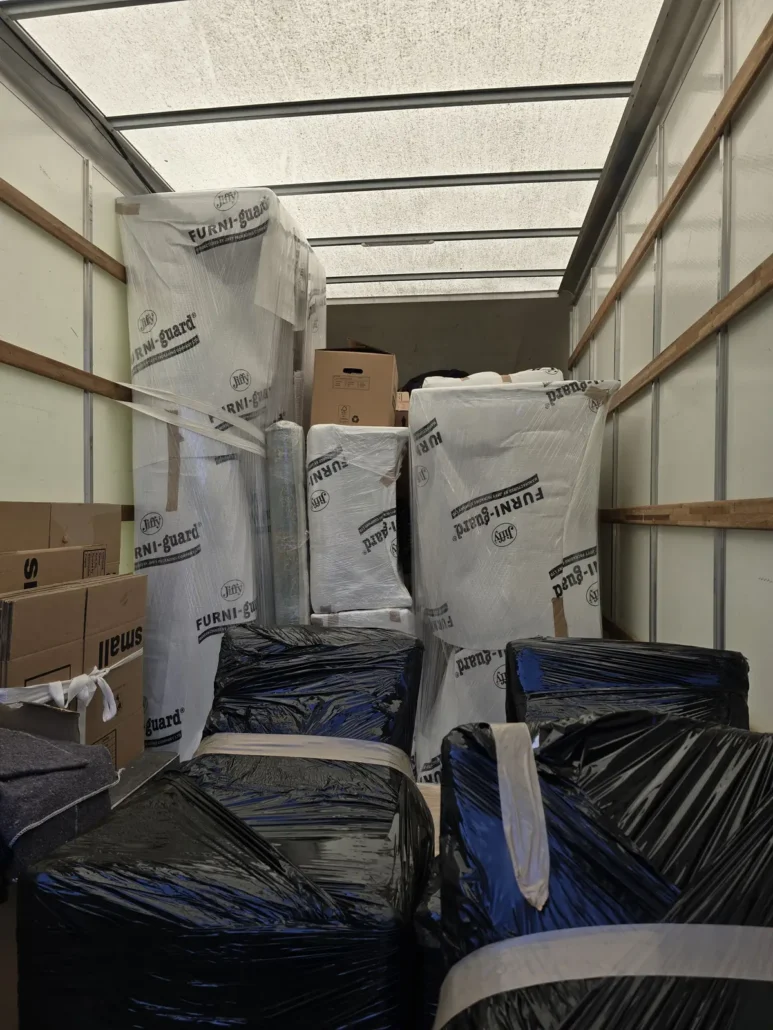 Removal van loaded with wrapped furniture and boxes