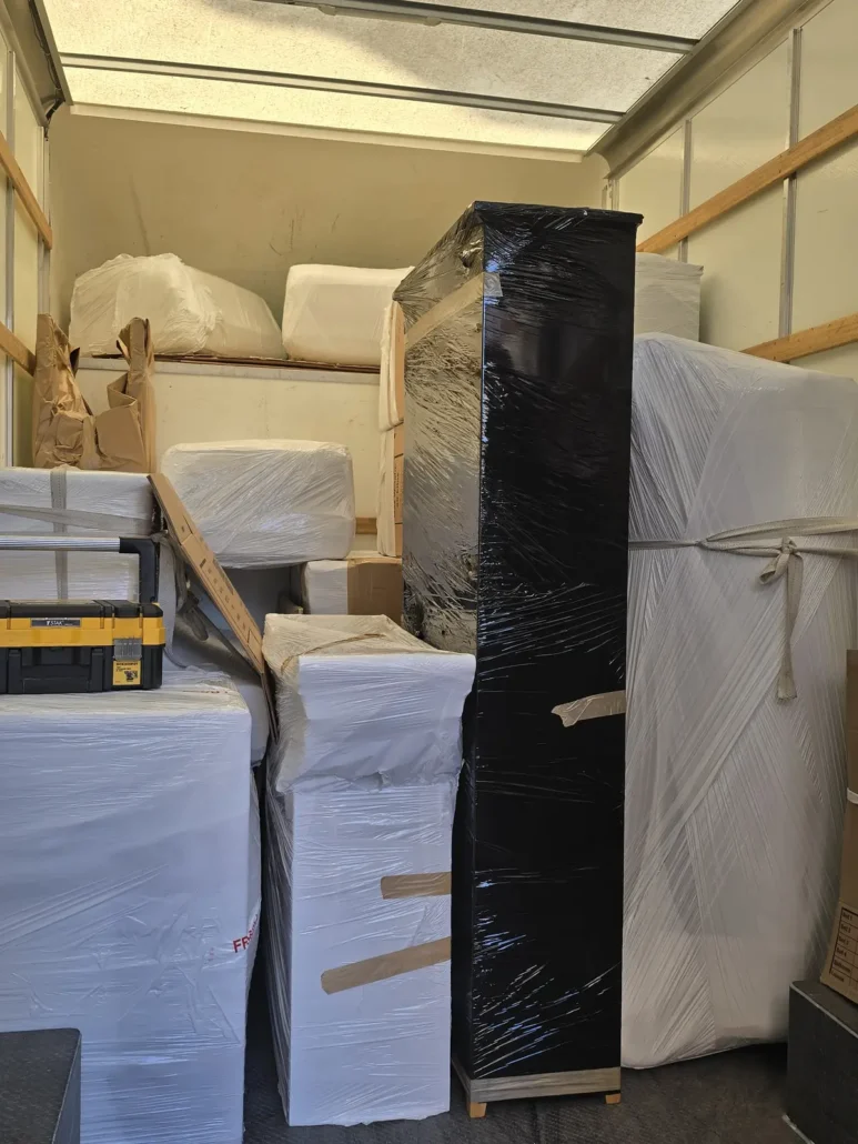 Wrapped furniture and boxes loaded in a removal van