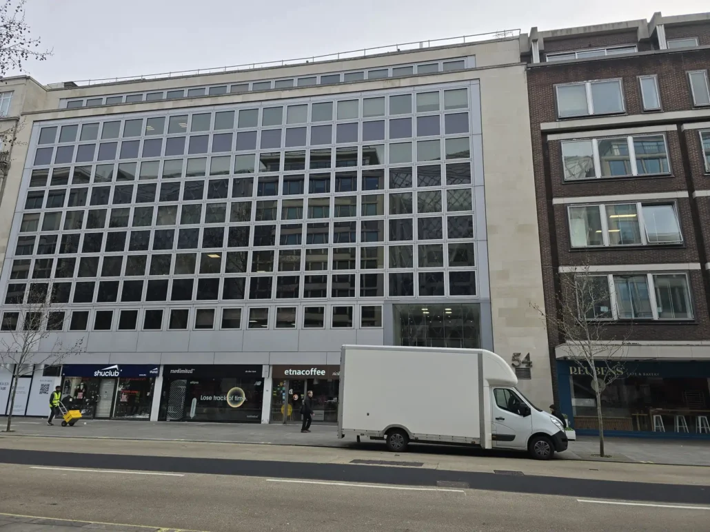 Removal van parked outside a London office building